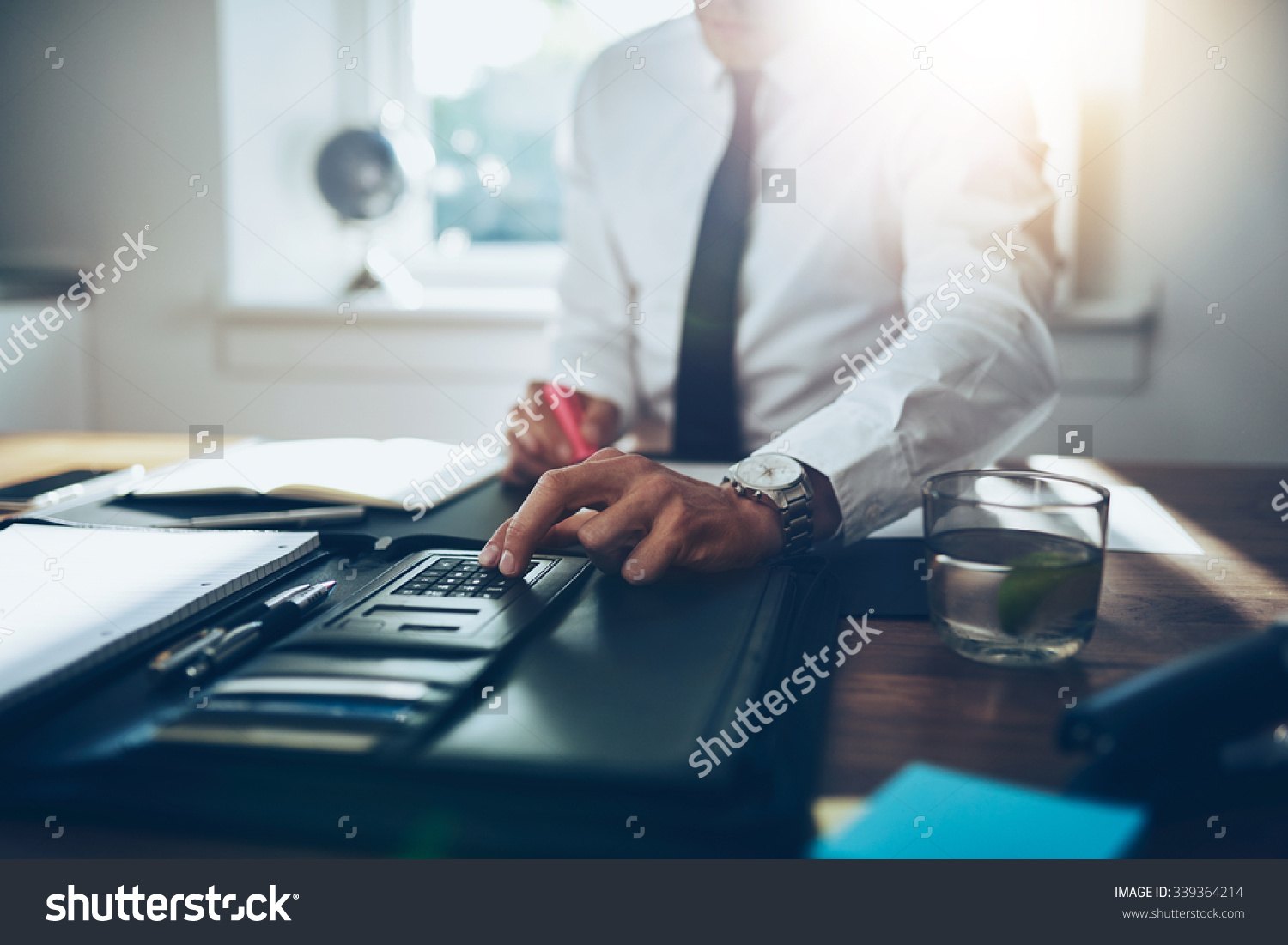 stock-photo-close-up-business-man-or-lawyer-accountant-working-on-accounts-using-a-calculator-and-writing-on-339364214