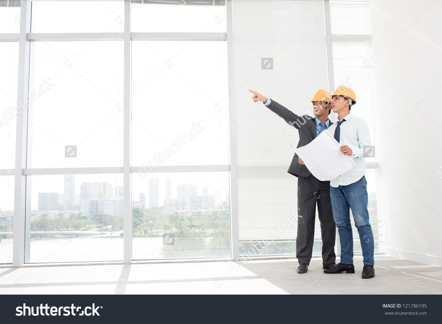 stock-photo-supervisors-in-hardhats-inspecting-empty-office-premises-121786195